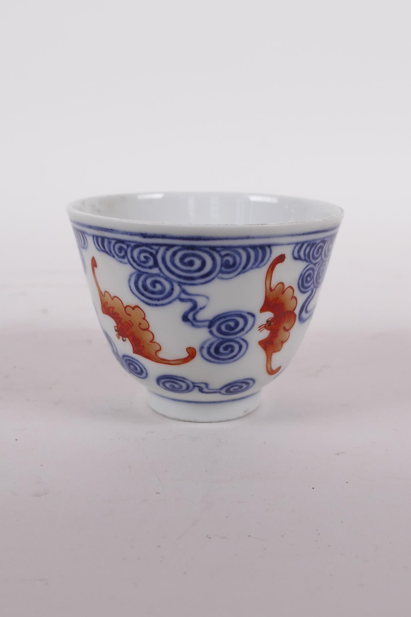 A Chinese blue and white porcelain tea bowl with iron red bat decoration, Quing six character mark - Image 2 of 5