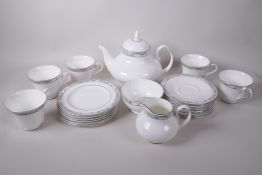 A Royal Doulton 'Arlington' pattern six place tea service with teapot, cream and sugar, 1 teacup