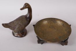 An Egyptian Revival engraved brass bowl supported by cast bird feet, 5" diameter and a bronze figure