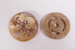 A Chinese carved horn roundel with kylin decoration, and a carved hardstone roundel, 2" diameter