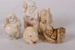 A collection of carved bone Japanese netsuke, four men and a piglet