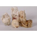 A collection of carved bone Japanese netsuke, four men and a piglet