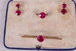 A suite of stone set yellow metal bar brooch, ring and earrings, stones test as ruby, boxed, ring