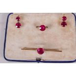 A suite of stone set yellow metal bar brooch, ring and earrings, stones test as ruby, boxed, ring