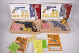 Two Daisy model 179 BB six gun air pistols, 'The spitting image of the famed Western six gun',