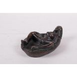 An bronzed metal ashtray of erotic form, 5" long