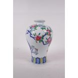 A Chinese polychrome porcelain baluster vase with pomegranate tree decoration, Qianlong seal mark to