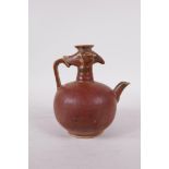 A Chinese porcelain phoenix pourer/wine jar with rust coloured glaze, 5" high