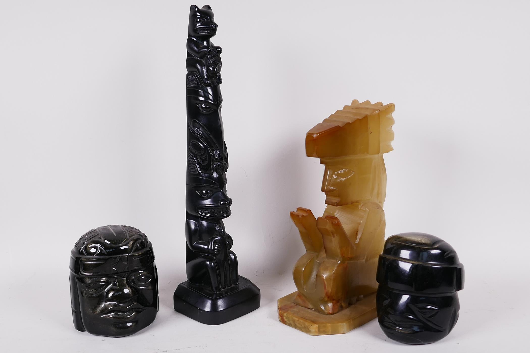 Two Mexican carved obsidian heads, a carved onyx seated figure 7" high, and a Canadian carved