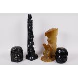 Two Mexican carved obsidian heads, a carved onyx seated figure 7" high, and a Canadian carved