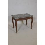 A C19th French oak low table, with shaped marble top, and carved and shaped apron, raised on