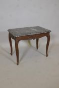 A C19th French oak low table, with shaped marble top, and carved and shaped apron, raised on