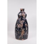 An art pottery terracotta lamp base with painted black and white decoration, A/F losses, 16½" high