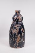 An art pottery terracotta lamp base with painted black and white decoration, A/F losses, 16½" high