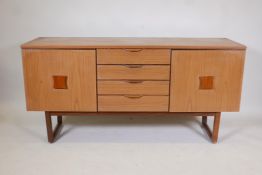 A 1970s Europa furniture sideboard, with two cupboards flanking a flight of drawers, 59" x 18",