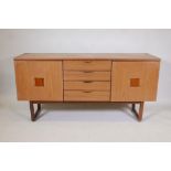 A 1970s Europa furniture sideboard, with two cupboards flanking a flight of drawers, 59" x 18",