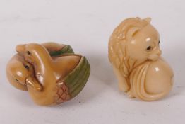 Two Japanese carved tagua nut netsuke, a lion and a pair of ducks