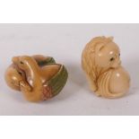 Two Japanese carved tagua nut netsuke, a lion and a pair of ducks