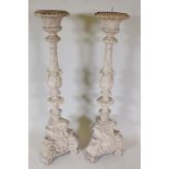 A pair of composition pricket candle stands in the form of classical columns, 47" high