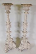 A pair of composition pricket candle stands in the form of classical columns, 47" high