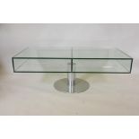 A late C20th glass coffee table on a pedestal base, 47" x 23", 17" high