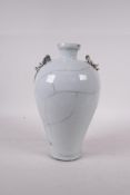 A Chinese crackleglazed porcelain vase with two dragon handles, 9" high