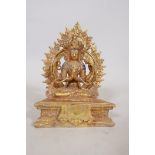 A gilt bronze four armed Buddha with enamel decoration, seated upon a plinth with detachable