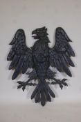 A painted aluminium wall plaque cast as an eagle, 42" x 36"