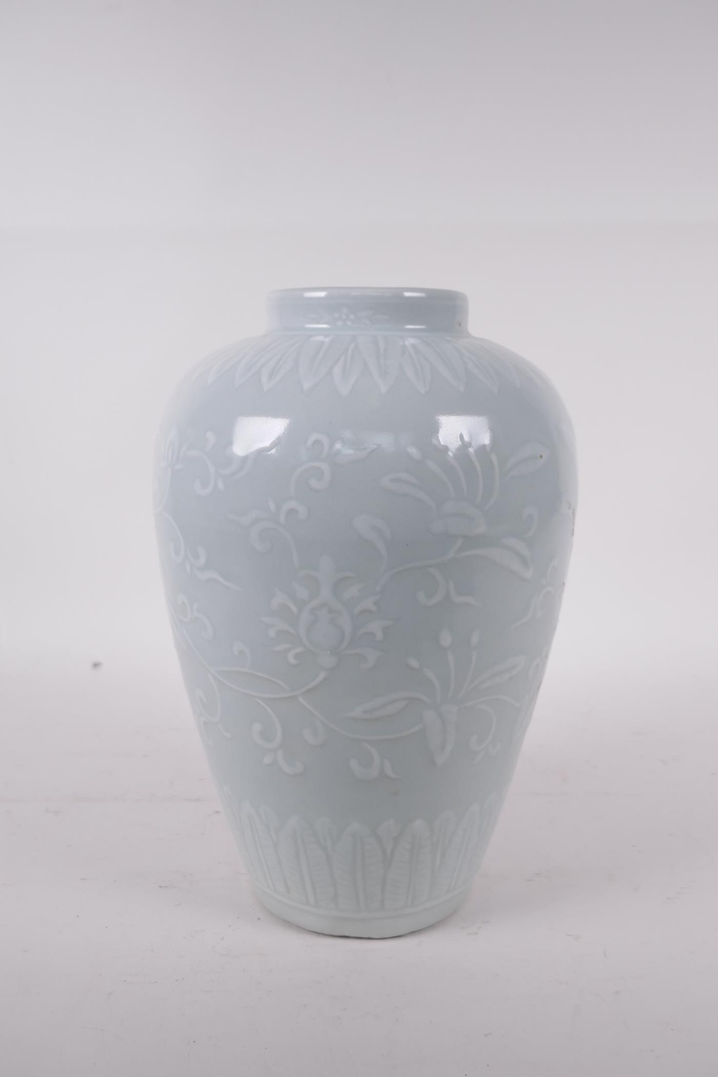 A celadon glazed porcelain jar with raised underglaze lotus flower decoration, incised six character - Image 3 of 5