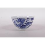 A Chinese blue and white porcelain tea bowl with dragon and phoenix decoration, Qing mark to base,