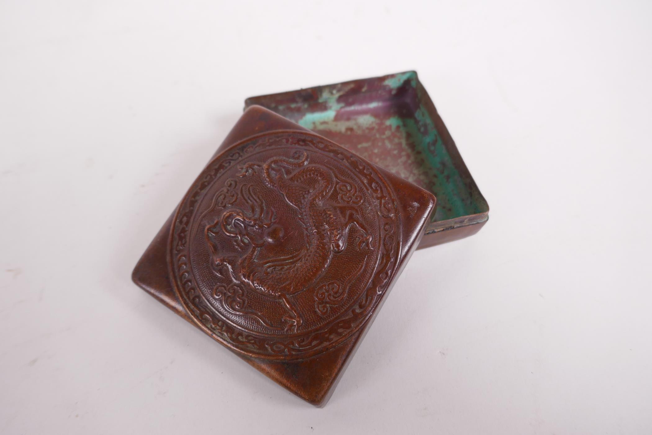 A bronzed copper ink box with repousse dragon decoration to the cover, impressed mark to base, - Image 2 of 3