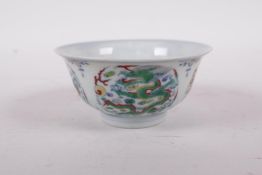 A Doucai porcelain rice bowl decorated with dragons, six character mark to base, 4" diameter