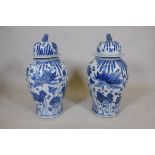 A pair of Chinese blue and white porcelain meiping jar and covers, decorated with carp in a lotus