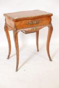 A French Louis XV style brass mounted tulip wood work table, the parquetry inlaid top lifting to