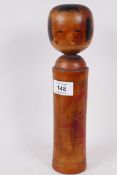 A Japanese turned and painted wood Kokeshi doll, 11" high
