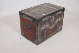 An early C19th painted leather trunk with brass stud decoration and steel straps, original papered