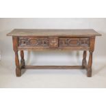 A C19th oak sideboard, with plank top and two drawers, carved sides and front, raised on turned