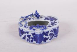 A Chinese blue and white porcelain ink well with applied bat and dragon decoration, 4" x 3"