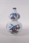 A Chinese polychrome porcelain double gourd vase, decorated with branches bearing fruit, six