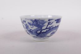 A Chinese blue and white porcelain tea bowl with dragon and phoenix decoration, Qing mark to base,