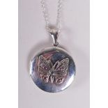 A 925 silver locket set with a butterfly, on a chain, 1½" drop