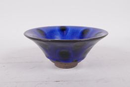 A Chinese Jian kiln pottery bowl with a blue spot glaze