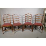 A set of four C19th mahogany ladder back chairs with drop in seats, 38" high