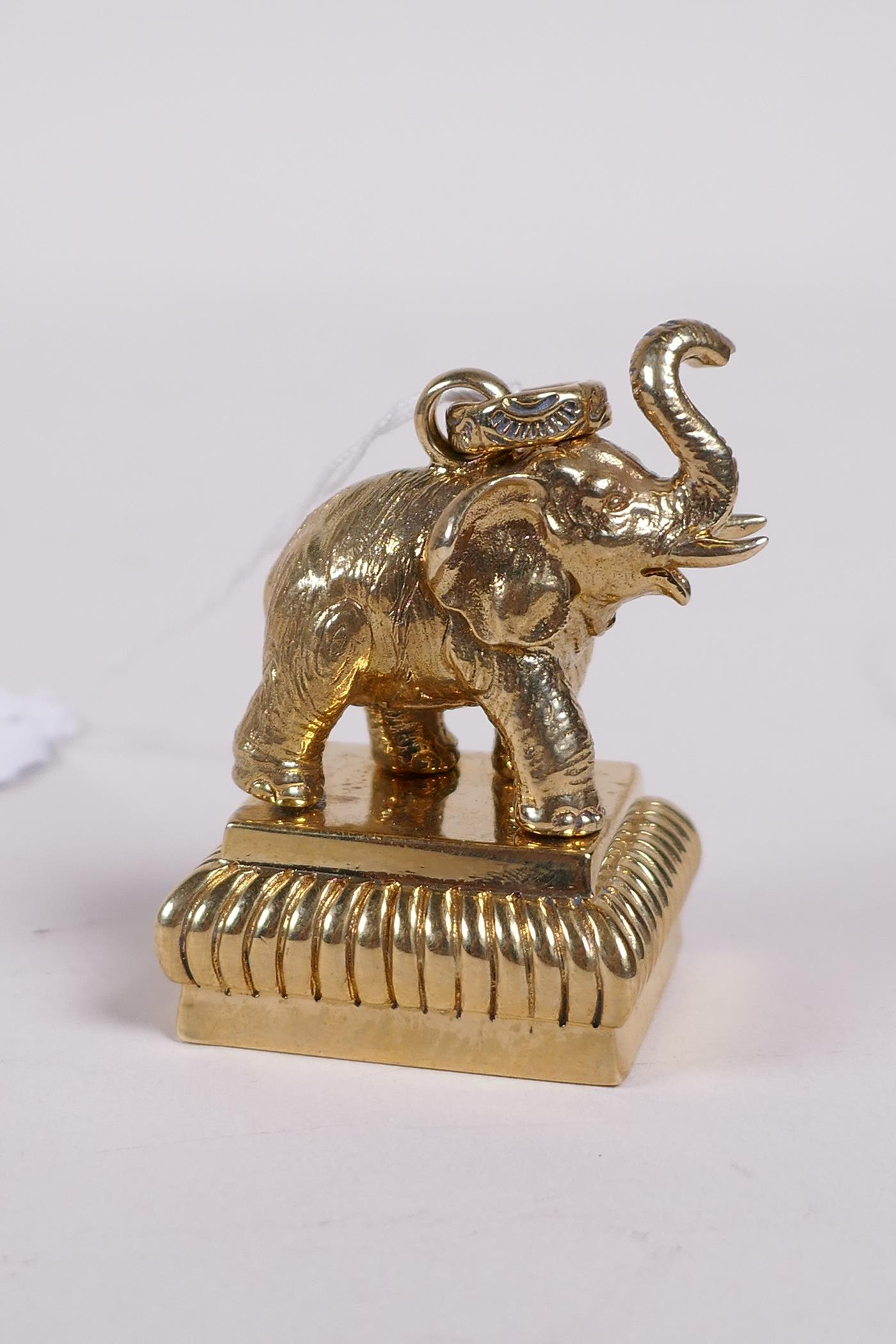 A gilt metal document seal with an elephant handle