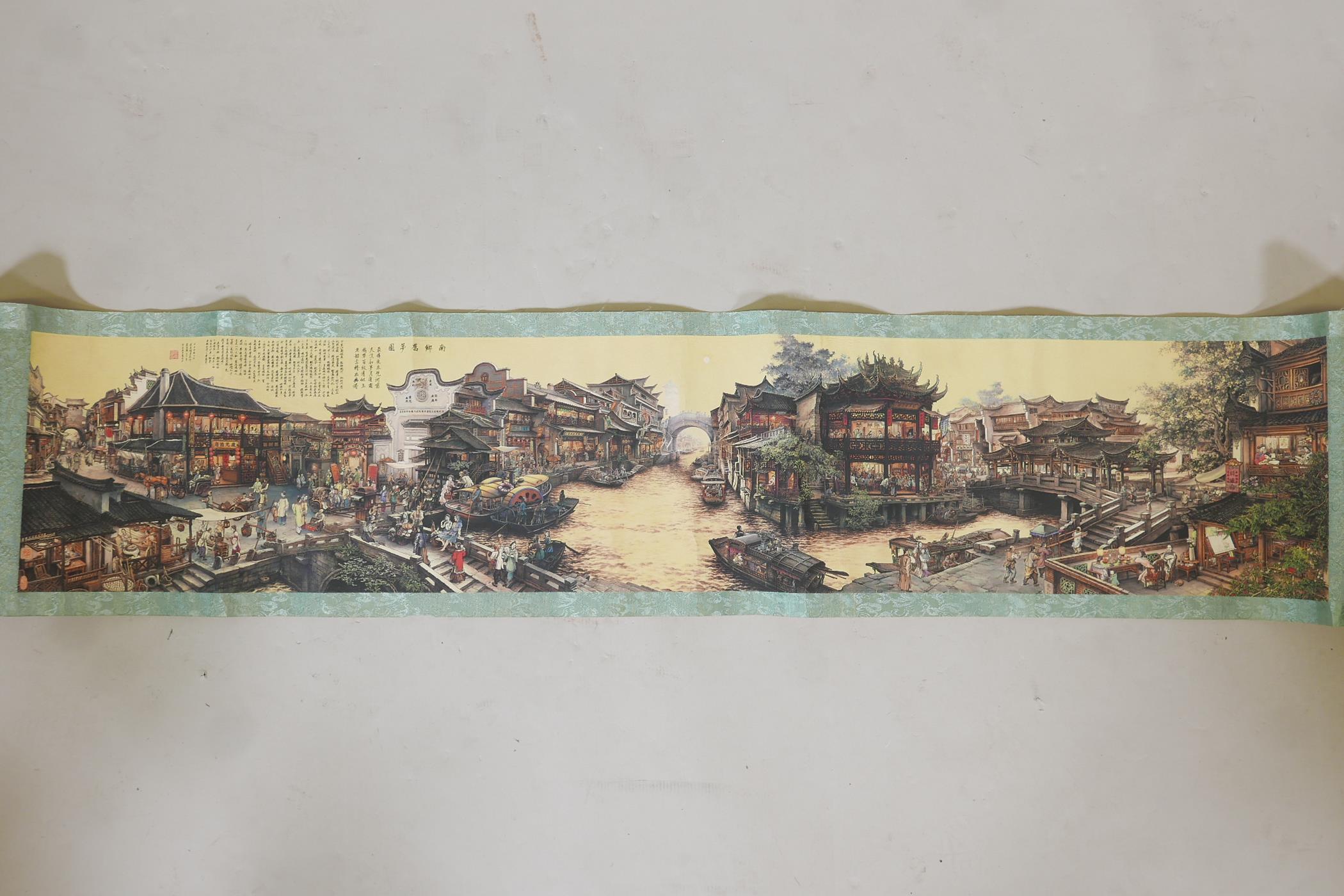 A Chinese printed scroll depicting a town scene, with character inscription panels to either end, - Image 2 of 7