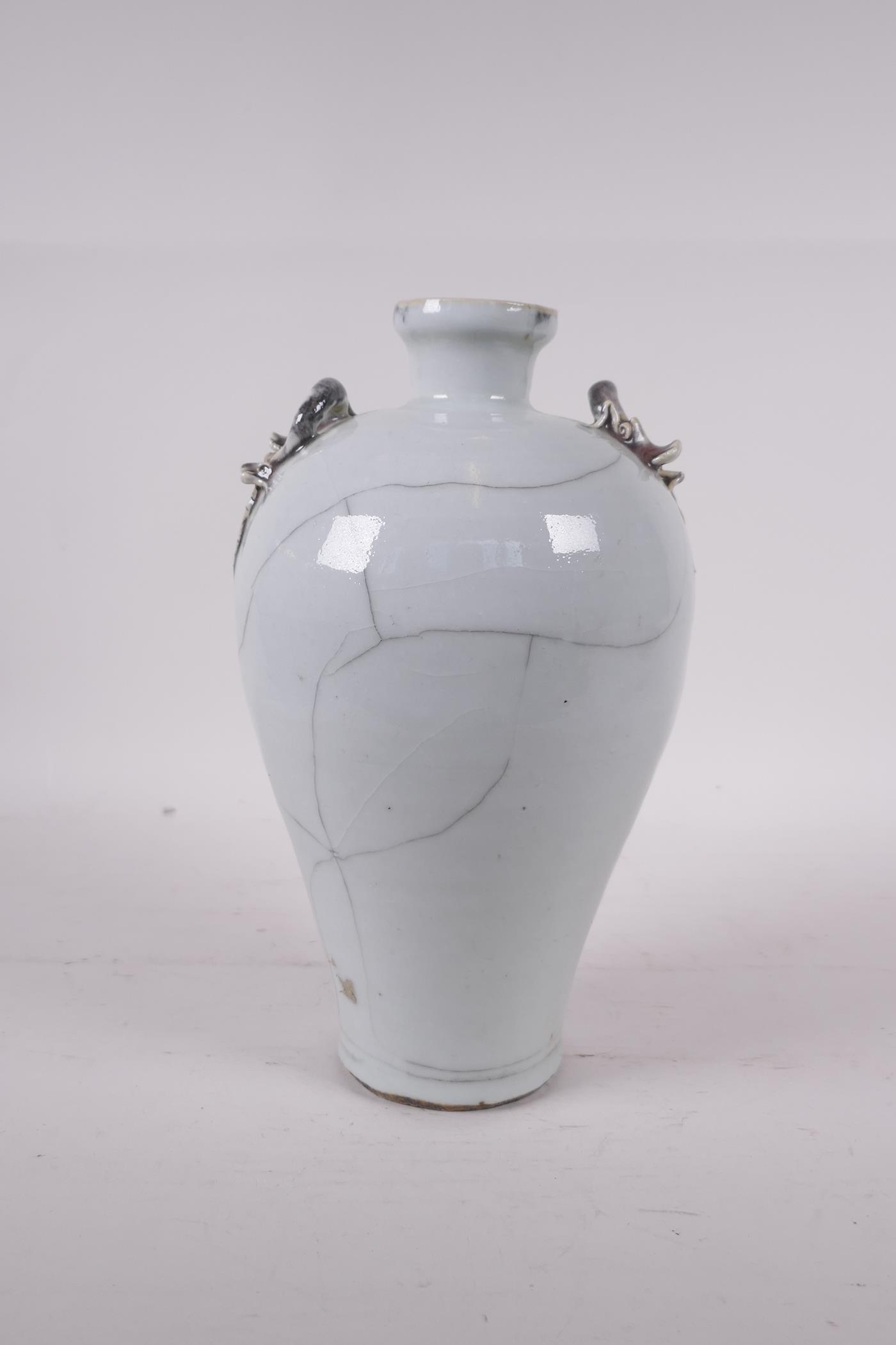 A Chinese crackleglazed porcelain vase with two dragon handles, 9" high