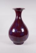 A Chinese flambe glazed pottery pear shaped vase, 13" high