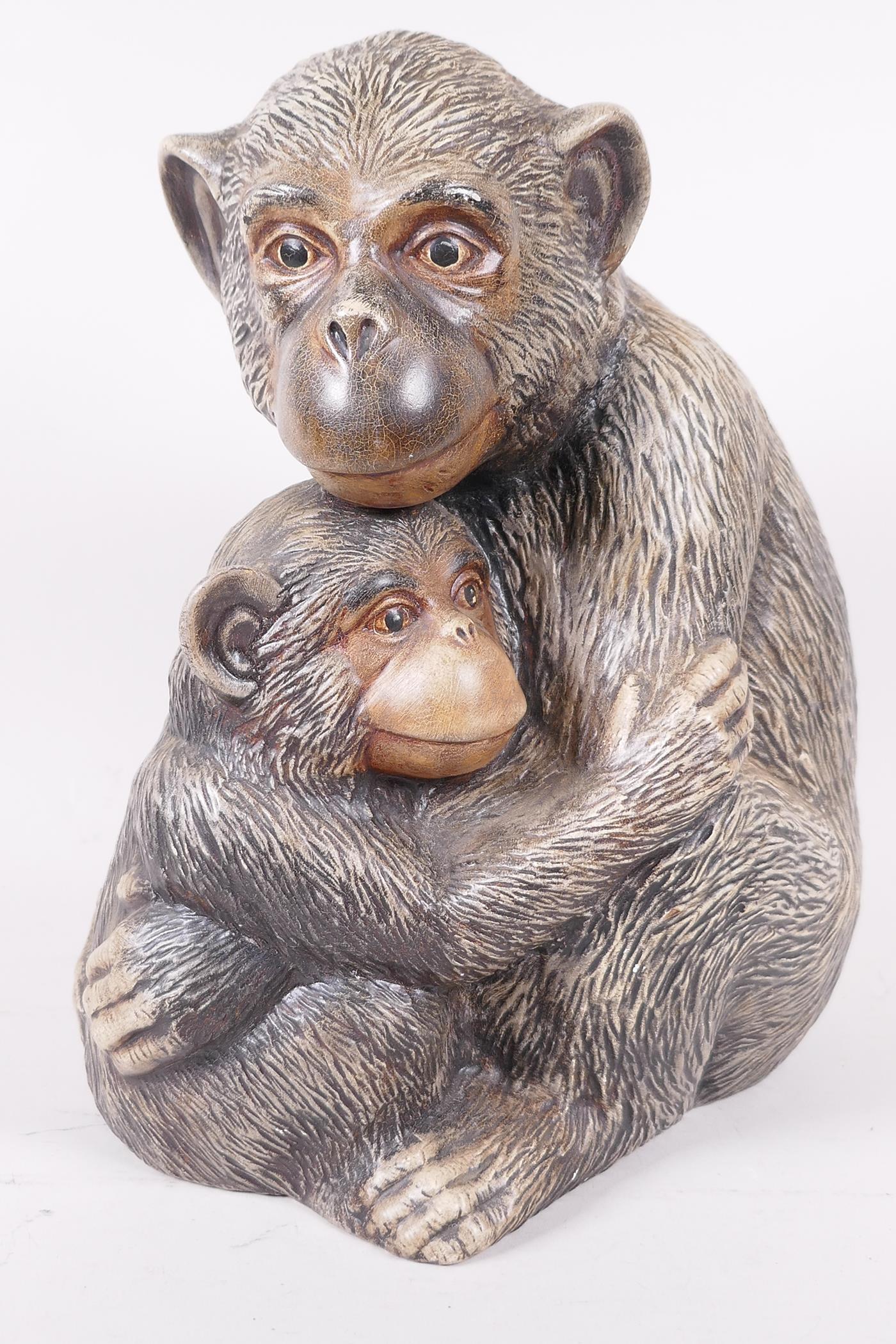 A well modelled plaster figure of two monkeys, 10" high