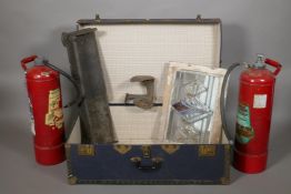 A travel trunk, a stained glass window, small fender, boot last and two fire extinguishers