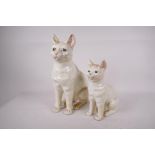 A pair of Portuguese pottery figures of cats, largest 12" high